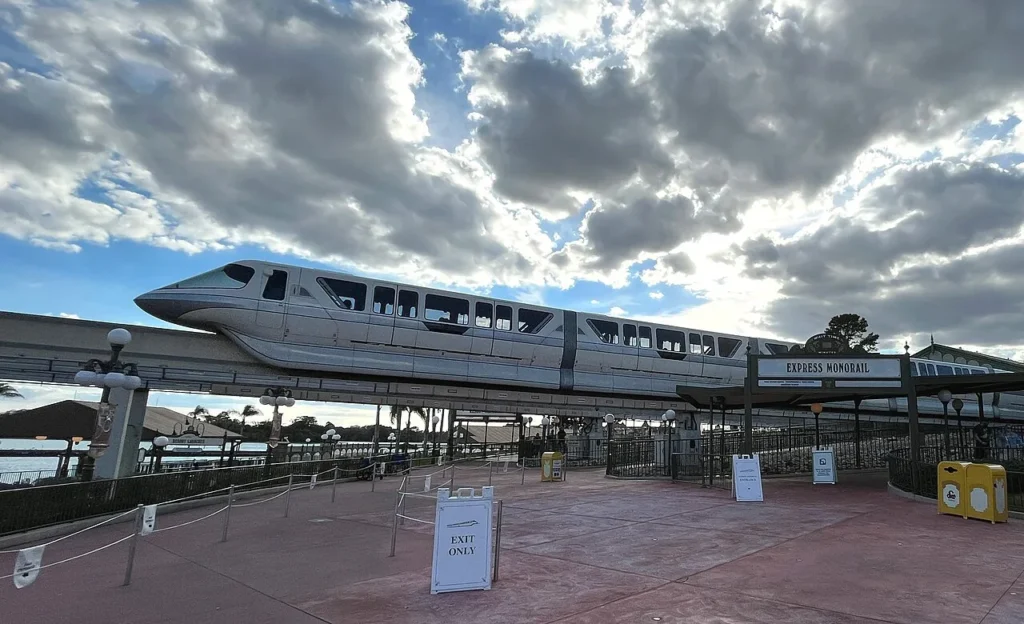 Walt Disney World monorail on its beam beside the Express Monorail entrance at Magic Kingdom