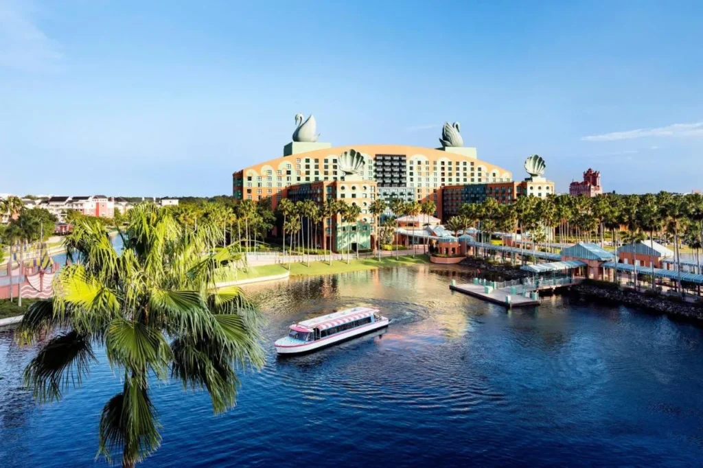 Walt Disney World Swan with its rooftop swan statues and a water taxi crossing the lake