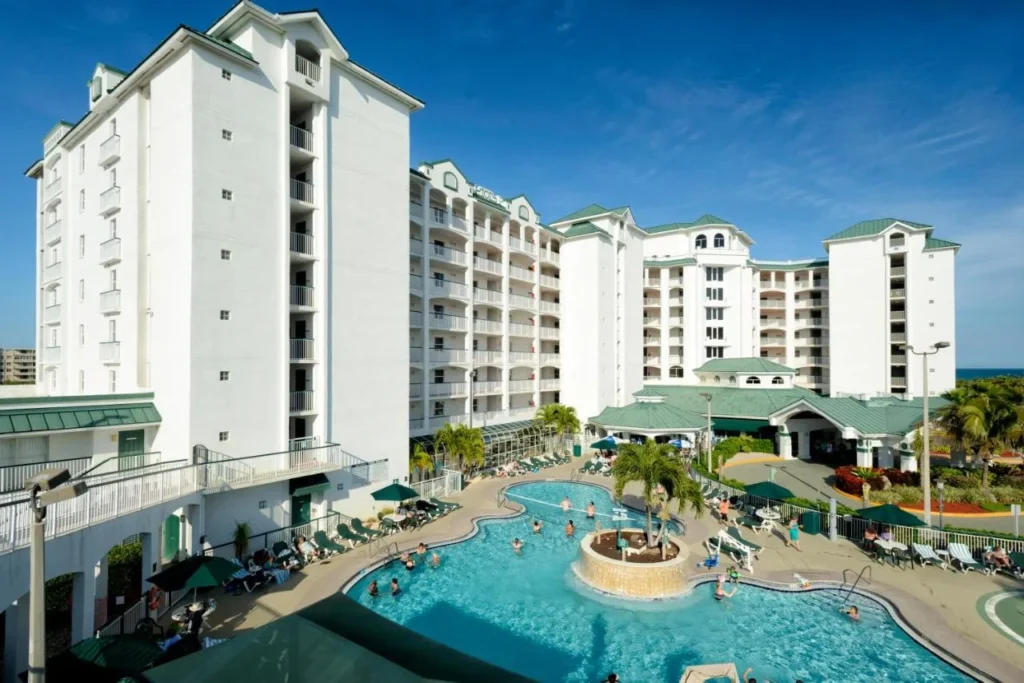 White condo towers above a busy free-form pool at The Resort on Cocoa Beach