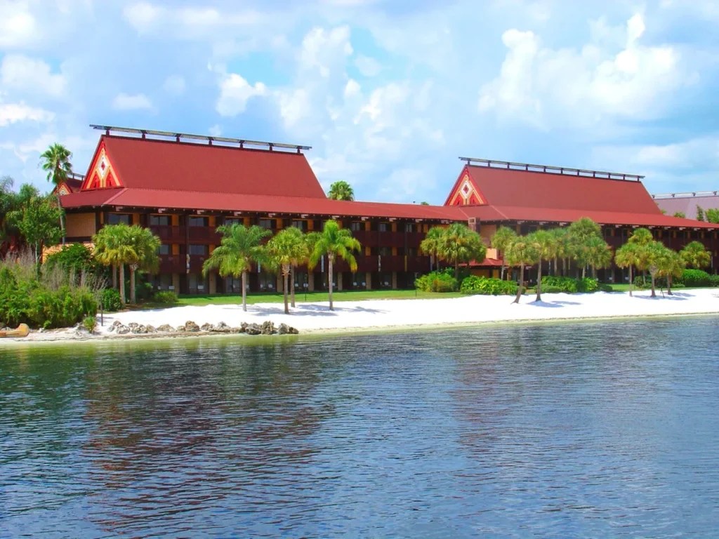 White-sand beach and palm trees in front of a longhouse at Disney's Polynesian Village Resort