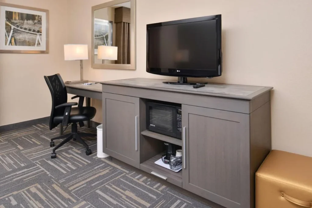 Work desk, flat-screen TV, microwave and coffee maker in a Hampton Inn Closest to Universal room