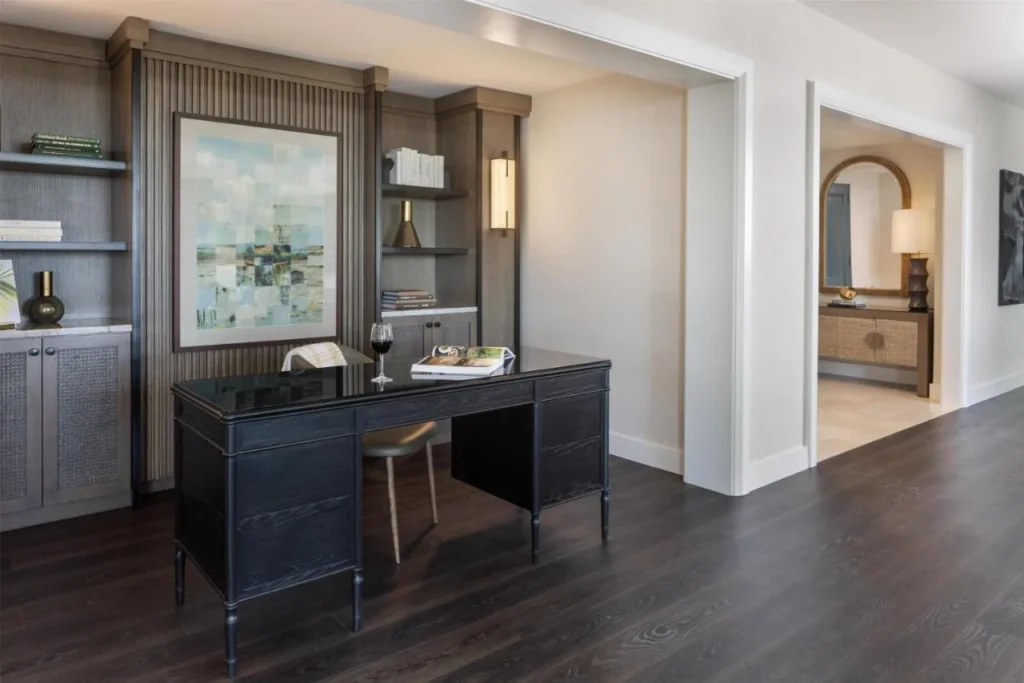 Writing desk, built-in shelves and entry hall inside a suite at Hilton Orlando
