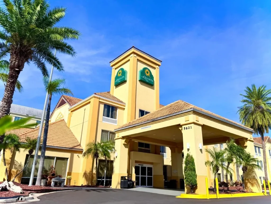 Yellow entrance canopy and sign tower at La Quinta by Wyndham Orlando Universal area