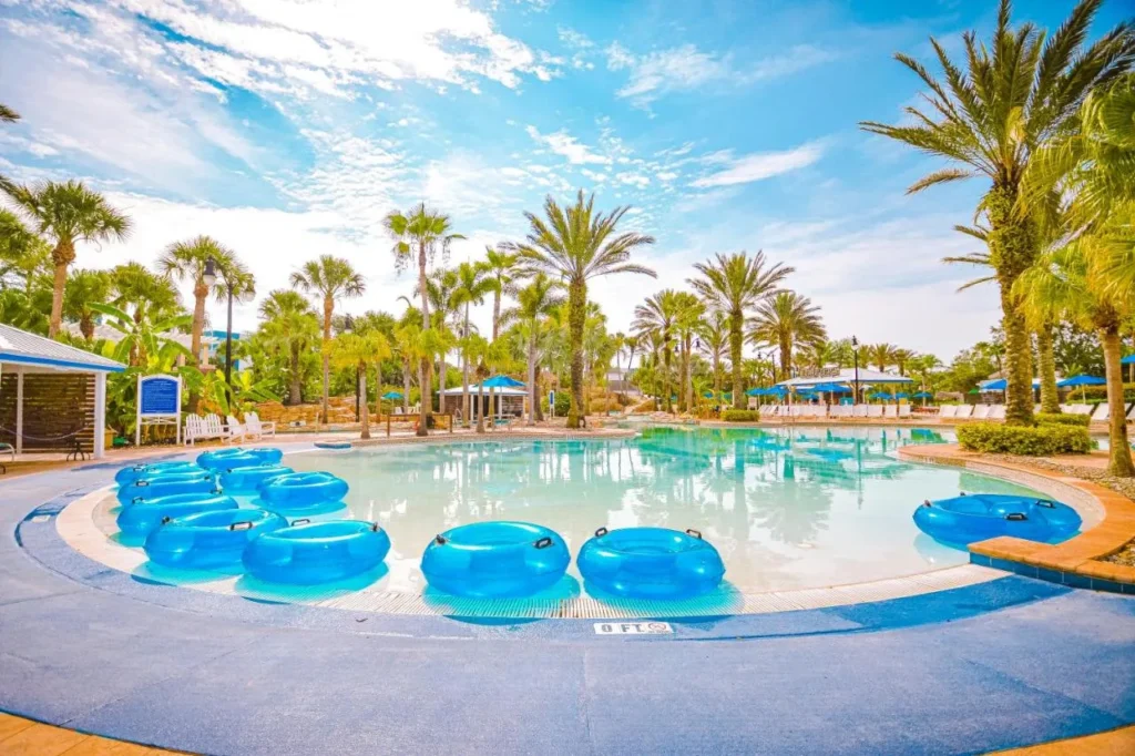 Zero-entry pool lined with blue lazy river tubes at the Reunion Resort water park
