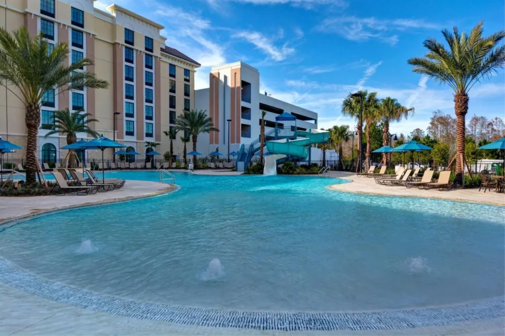 Zero-entry pool with spiral waterslide at Home2 Suites by Hilton Orlando Flamingo Crossings